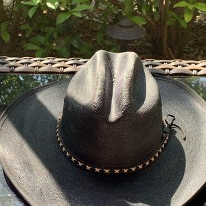Black straw cowboy hat with black and white hat band